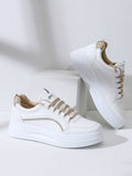 Minimalist white sneakers with brown details