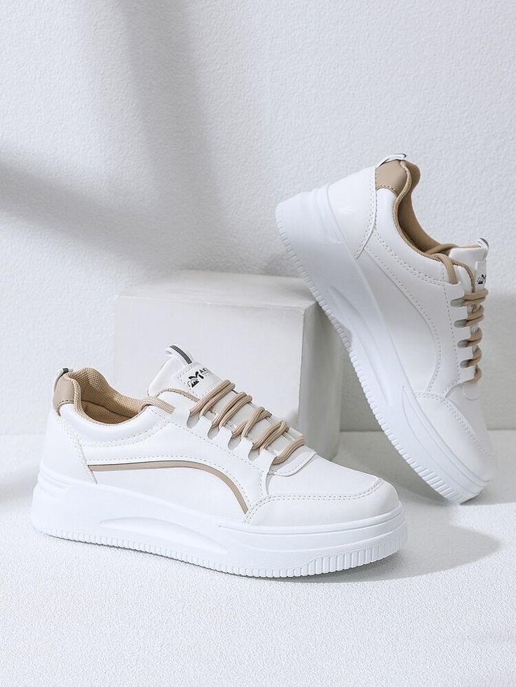 Minimalist white sneakers with brown details